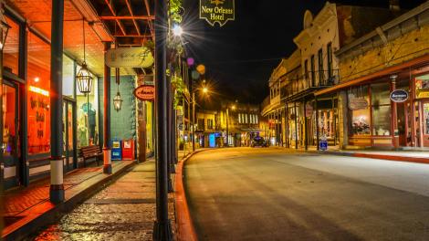 Nighttime view of the 1892 New Orleans Hotel and Spring Street downtown