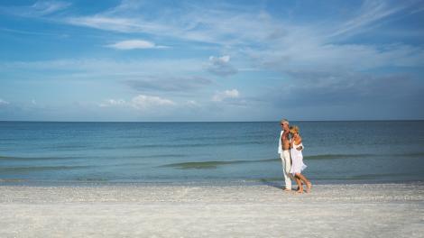 A couple walking the Beach in Naples, Florida