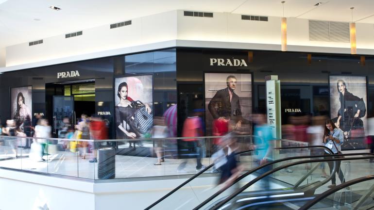 Shoppers visit Prada, located on the second floor of the Fashion Outlets of Chicago