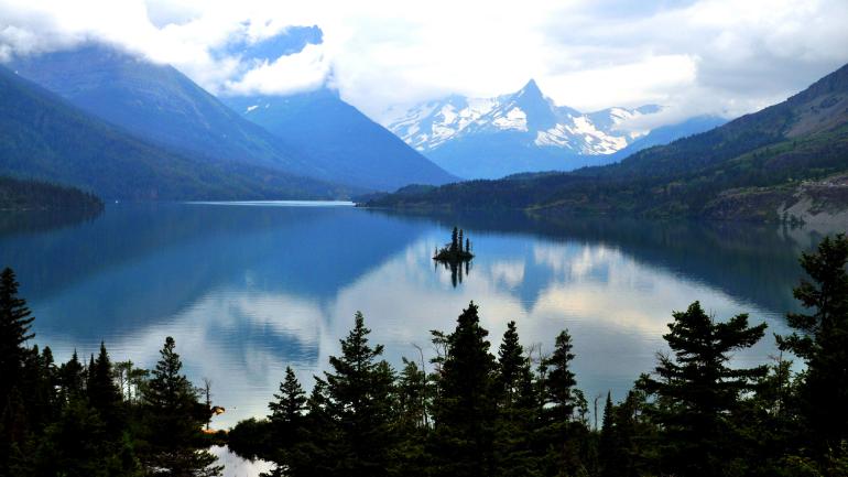 The big (and ever-changing) skies of Glacier National Park reflected in a glacial lake