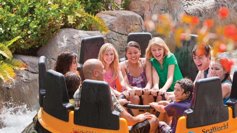 Friends enjoying a spin on Shipwreck Rapids at SeaWorld San Diego