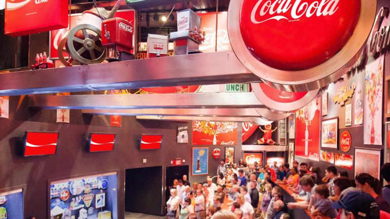 Visitors learning more about Coca-Cola history in the Loft exhibit at World of Coca-Cola 