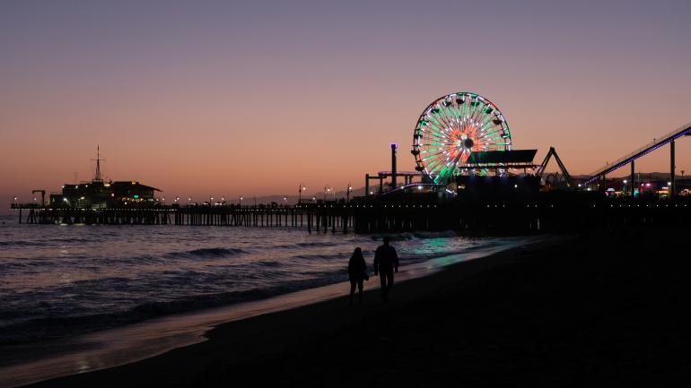 The sun sets over the pier outside Los Angeles, California.
