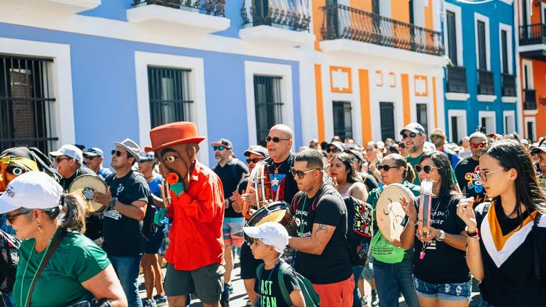 Revelers take to the streets during Fiestas de la Calle San Sebastian in San Juan