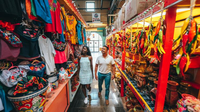 A young couple wander a vibrant market in San Antonio