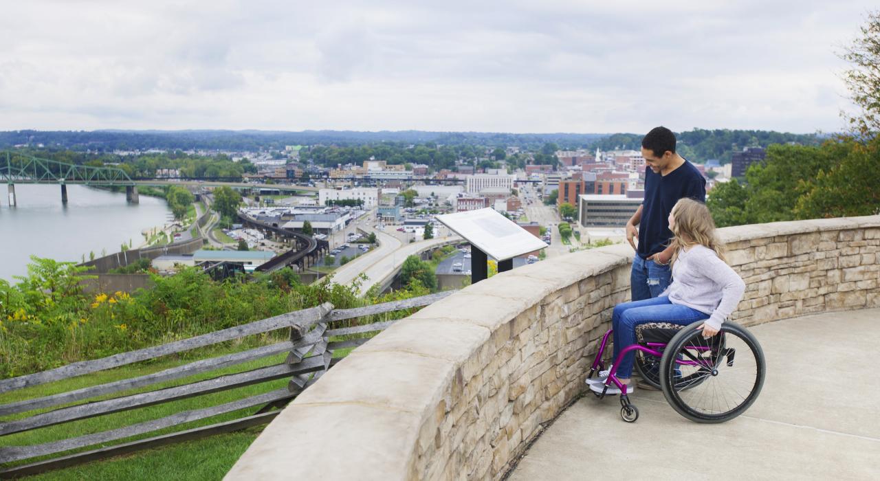 A couple admiring the skyline and nature views of Columbus, Ohio, from an accessible overlook