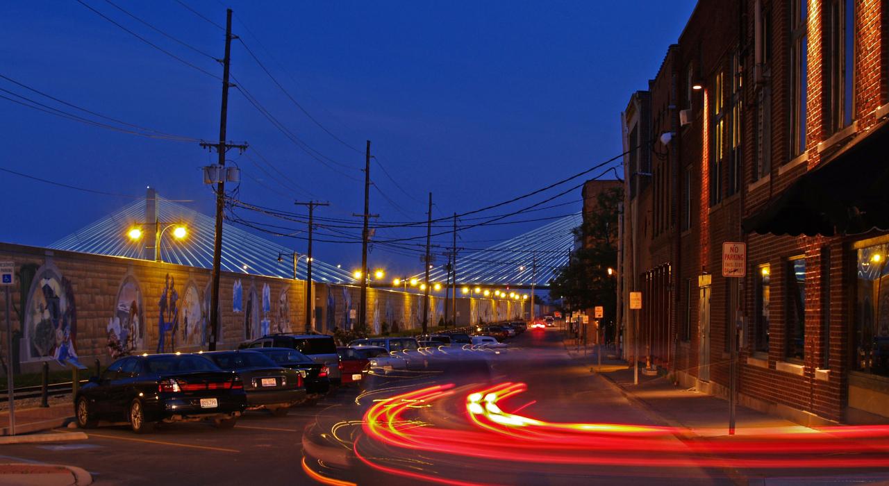 Nighttime view of the River Tales mural on Water Street
