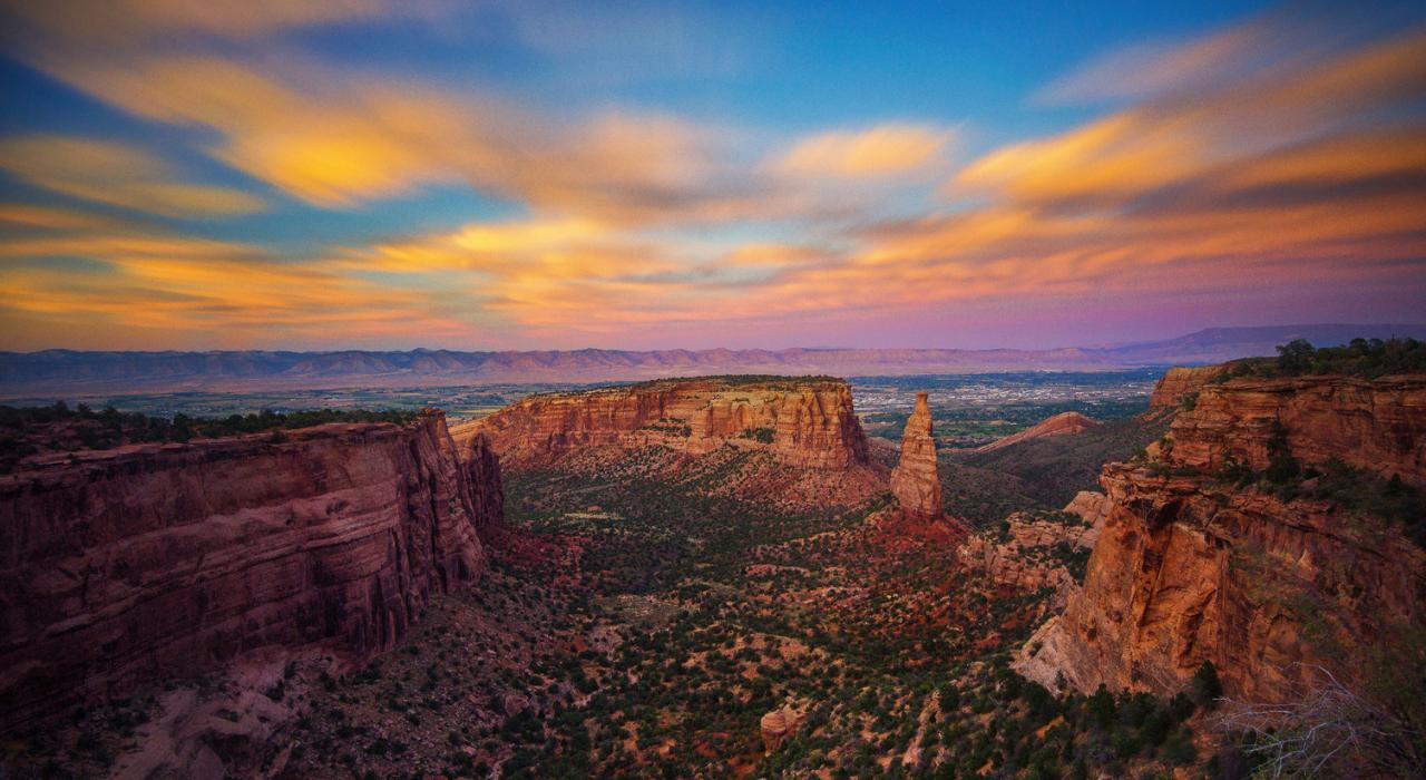大章克申附近科罗拉多州国家纪念公园红色岩石上方的日出美景