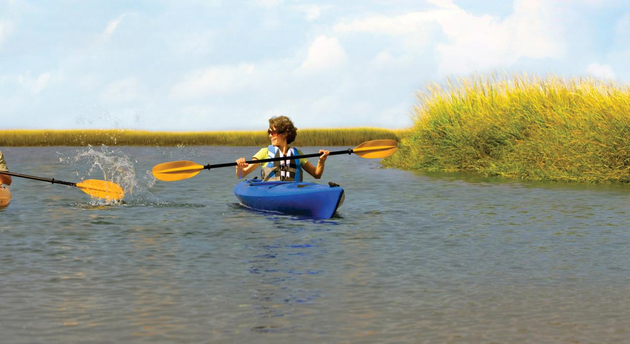 乘坐皮划艇沿着盐沼旁的内陆溪流顺流而下