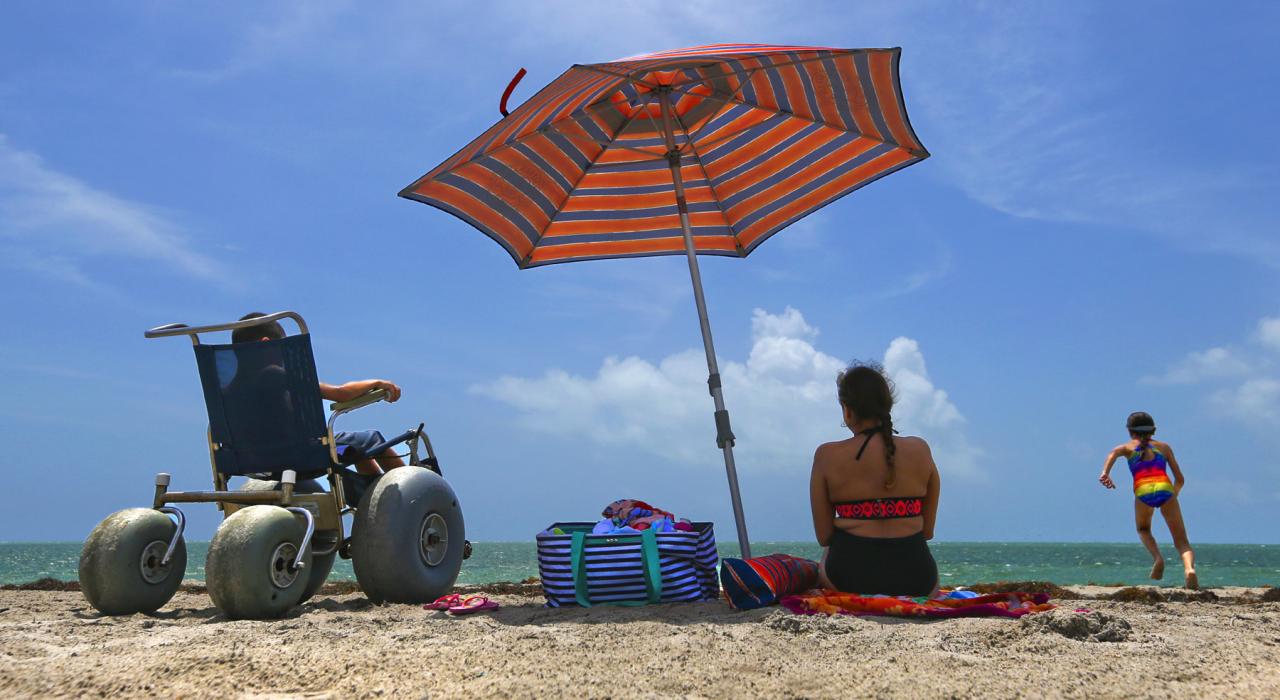 Enjoying an accessible beach in Key Biscayne, Florida, with the help of a sand wheelchair