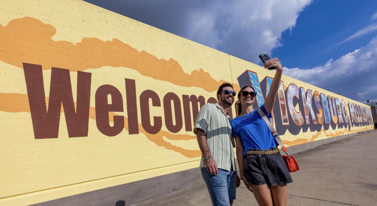 Posing by the Welcome to Vicksburg mural in Downtown Vicksburg