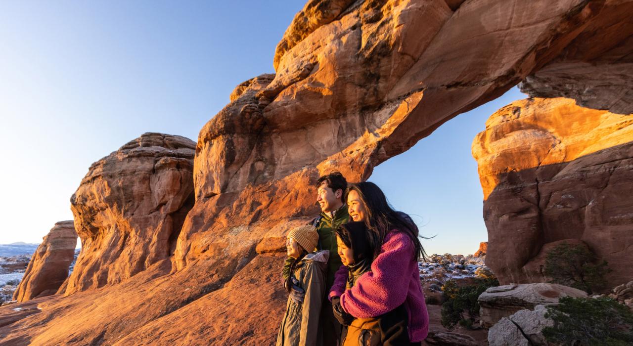 A family sharing an incredible view at Arches National Park in Utah
