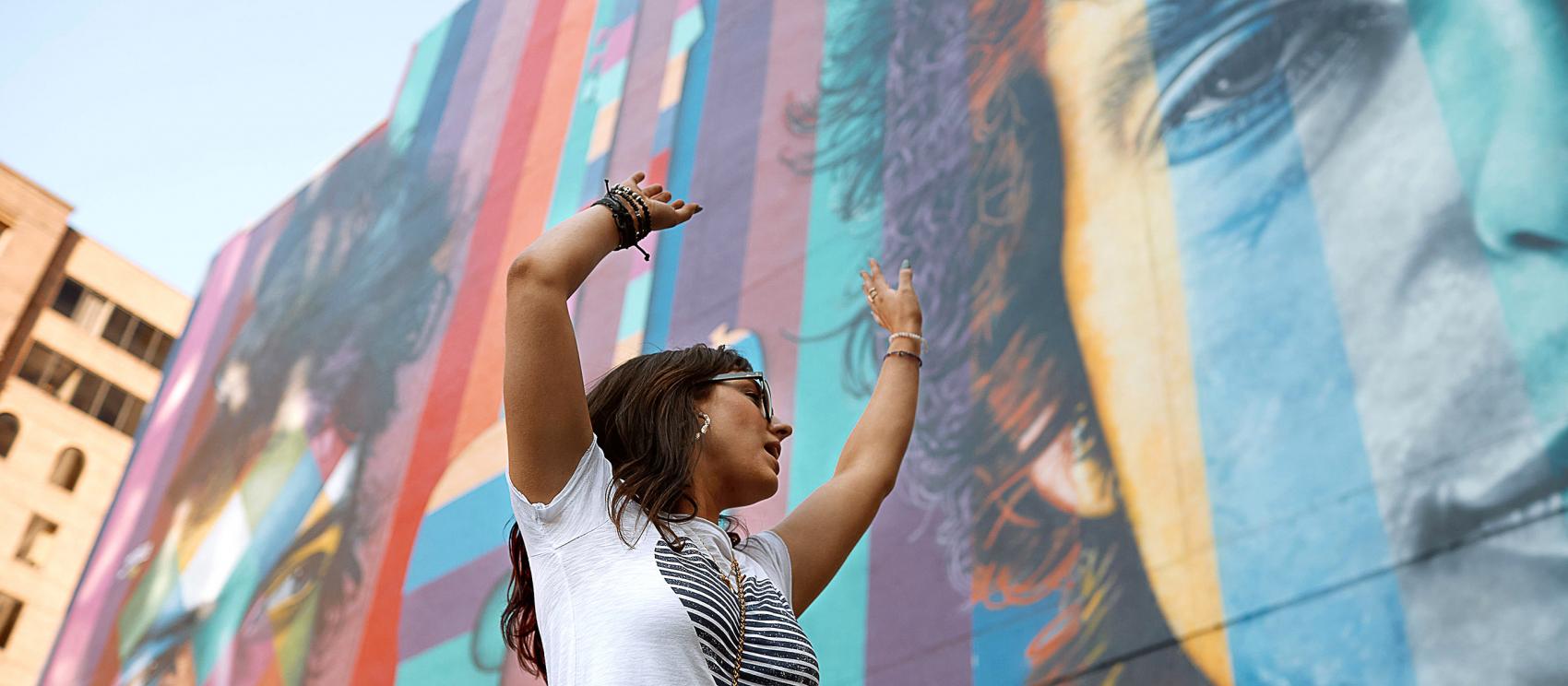 在明尼阿波利斯的鲍勃·迪伦纪念壁画前拍照