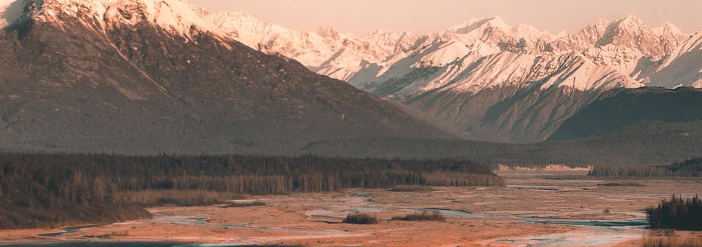 Sunlit, snow-capped mountains in Alaska Sunlit, snow-capped mountains in Alaska